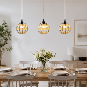 globe pendant light over a warm kitchen counter