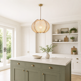 wood pendant light over a warm kitchen counter