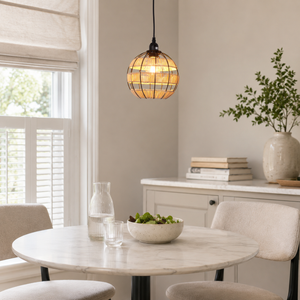 globe pendant light in a sunlit breakfast nook