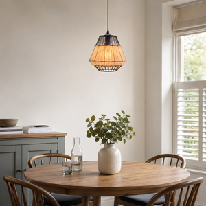 rattan iron pendant light above a bright dining table