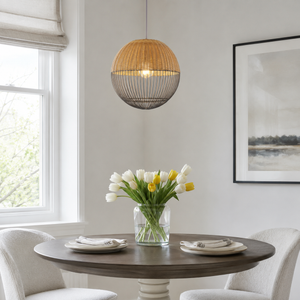 rattan iron globe pendant light above a bright dining table