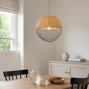 rattan iron globe pendant light beside a bright window