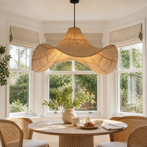 Brown and white rattan pendant in a sunlit round dining nook