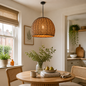 rattan wave-detail pendant light above a bright dining table