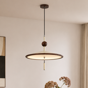 beige iron pendant light with beige iron shade above a round table