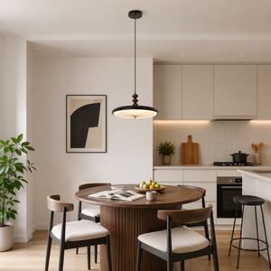 black pleated pendant light above a kitchen dining table