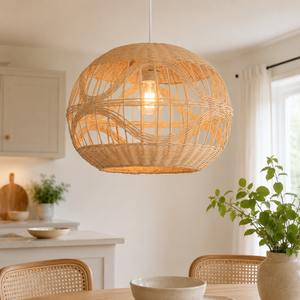 Handwoven spherical rattan pendant glowing in a kitchen nook