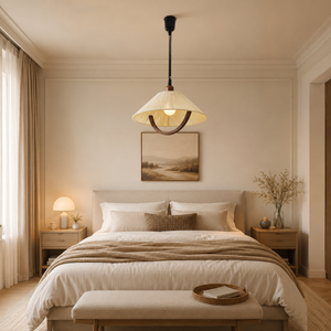 natural wood curved pendant light above a bed in a calm bedroom