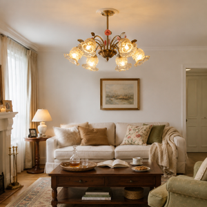 6-light gold vintage pink floral glass chandelier above a neutral living room sofa