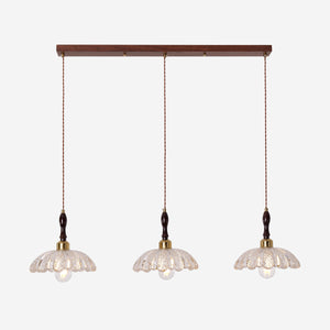3-light walnut resin mini pendant in a warm living room
