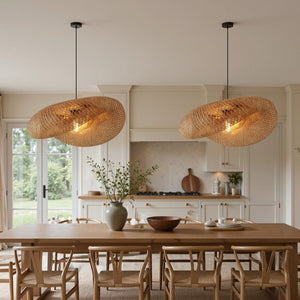 pair of bamboo pendant lights over a rustic dining table in a bright kitchen
