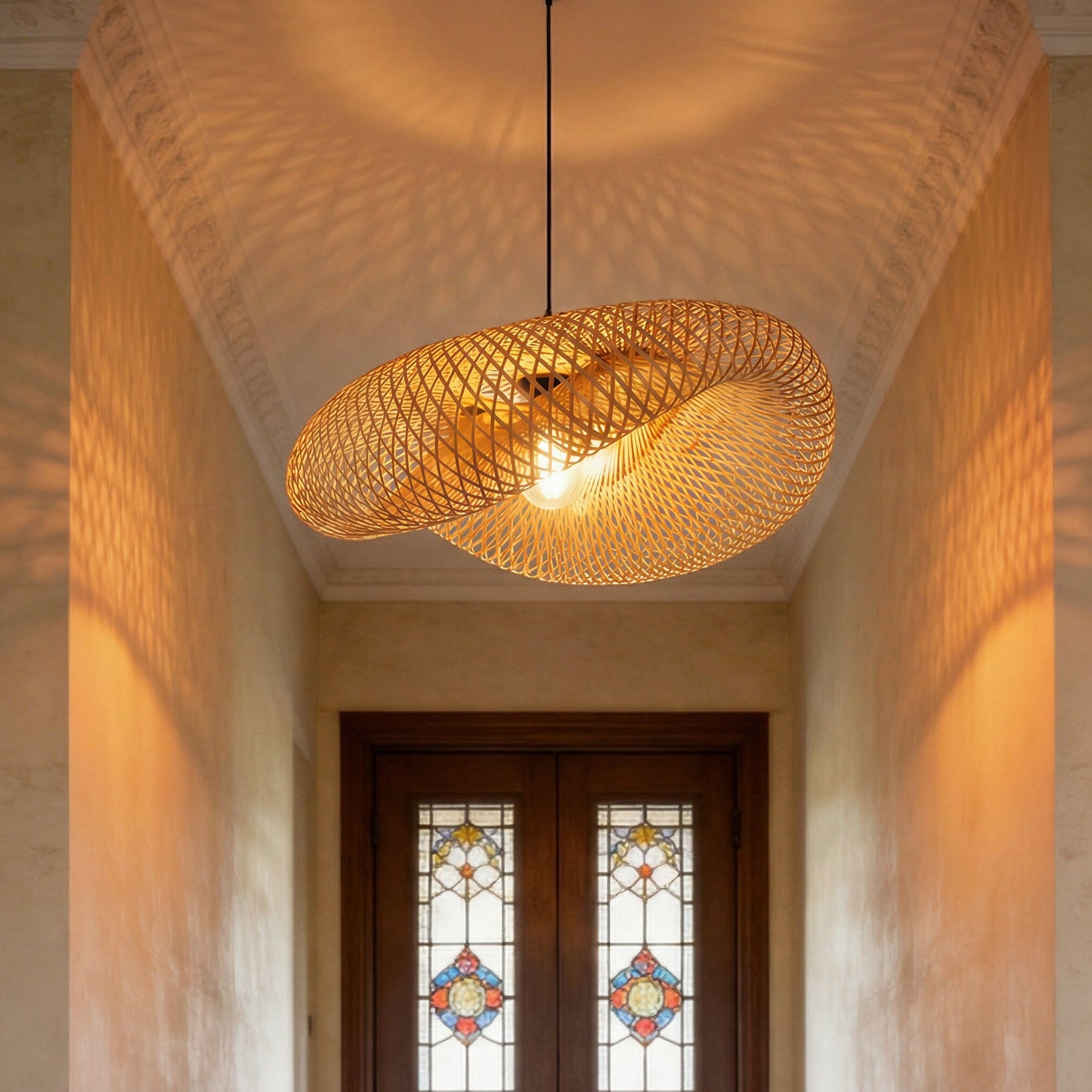 bamboo pendant light casting warm woven shadows in a narrow hallway