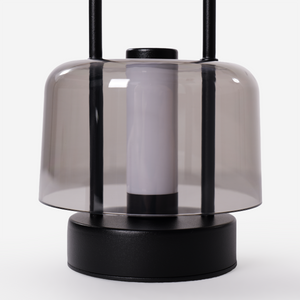 portable lantern-style ambient table lamp on a desk with soft ambient light