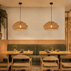 two rattan spiral pendant lights in a cosy restaurant booth dining area