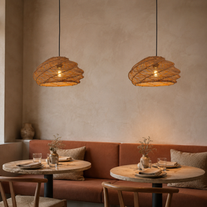 pair of woven rattan pendant lights above a warm restaurant dining table