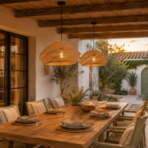 spiral rattan pendant lights over a covered patio dining table at sunset