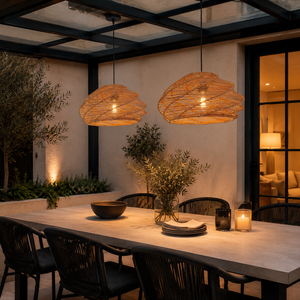 warm rattan pendant lights above an evening terrace dining table