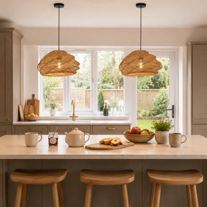 pair of woven rattan pendant lights above a breakfast bar by garden windows
