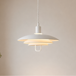 white layered minimalist pendant light hung above a dining table
