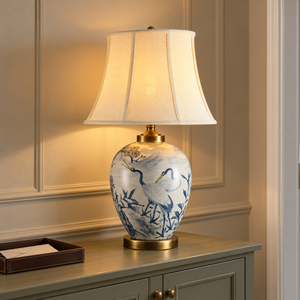 Blue crane ceramic table lamp lighting a green console in the hallway