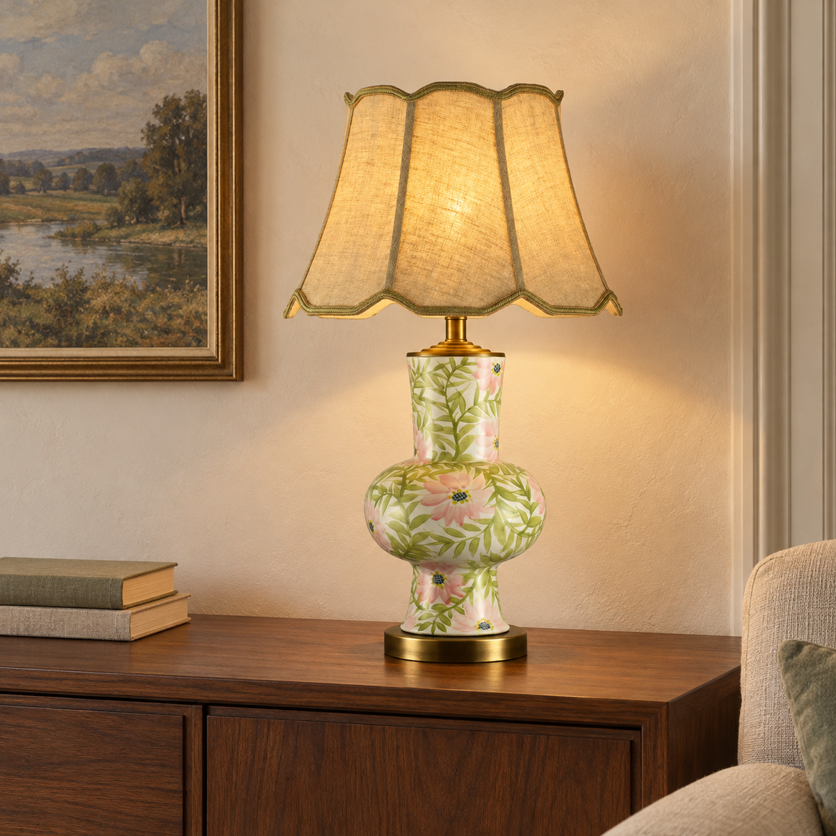 Slim pink floral ceramic lamp with scalloped shade on a wooden console