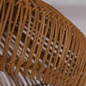 Natural rattan ceiling lamp hanging over dining table