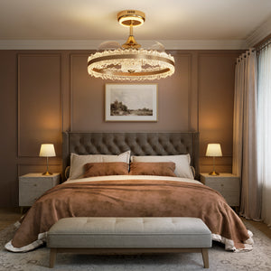 Gold halo ceiling fan light casting warm light above a brown bedroom scheme