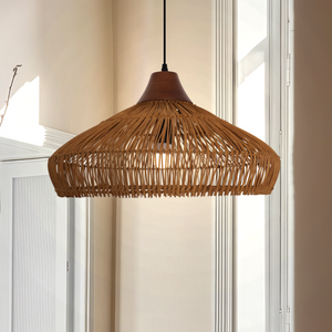 Natural rattan ceiling lamp hanging over dining table
