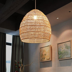 Natural rattan pendant light glowing in a modern art-filled dining room