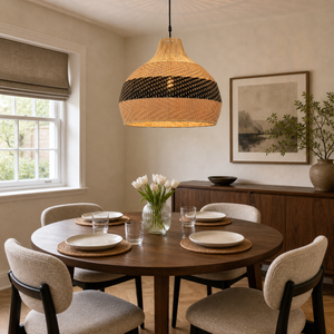 black rattan pendant light above a bright dining table