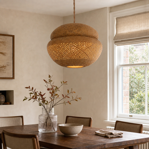 handwoven bulrush - eco-friendly pendant light above a bright dining table