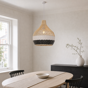 black white rattan pendant light above a bright dining table