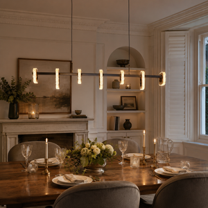 gold linear led acrylic pendant light beside a bright window