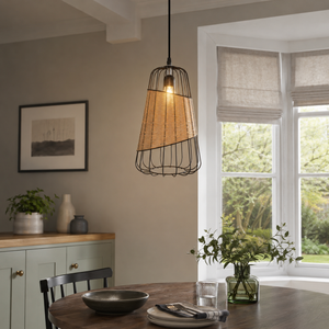 rattan iron pendant light above an open-plan dining space
