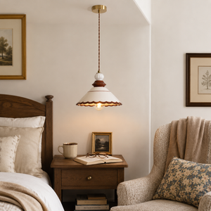 brown ceramic lace pendant light beside a bed with warm ambient light