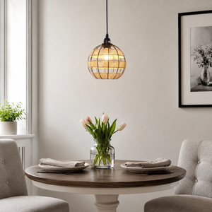 globe pendant light beside a bright window
