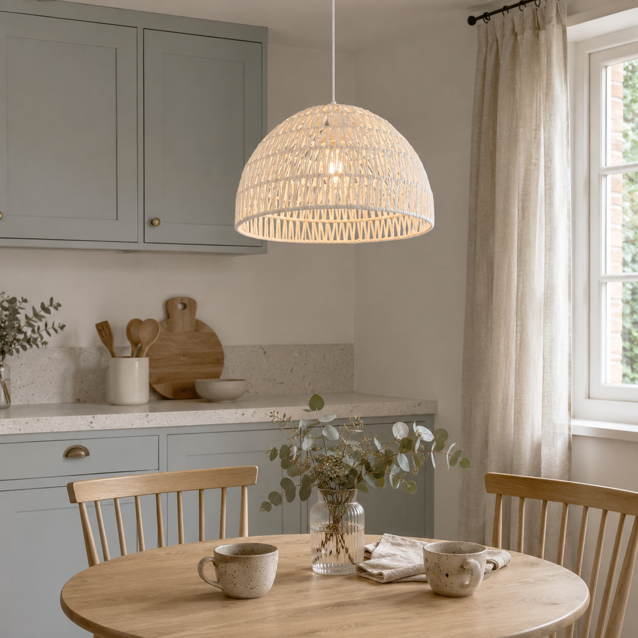 White rope ceiling pendant glowing by a round table