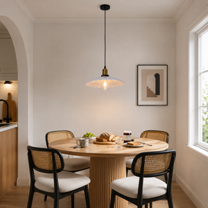 white iron pendant light above a dining table in a bright room