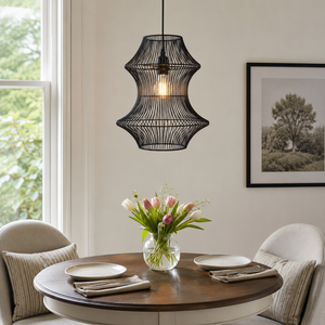 black rattan iron pendant light above a bright dining table
