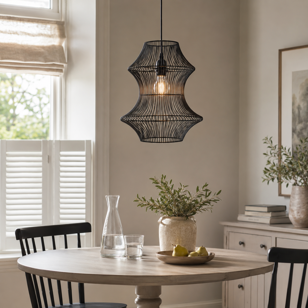 black rattan iron pendant light over a warm kitchen counter