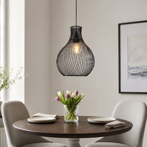 black iron pendant light above a bright dining table
