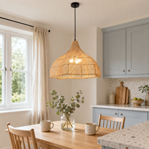 Bamboo rattan pendant light glowing over a round table
