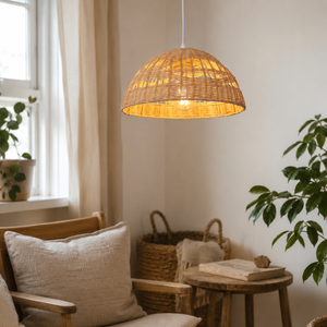 rattan dome wave-detail pendant light beside a bright window