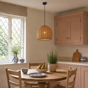 rattan wave-detail pendant light above a cozy living room table