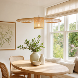 Fan-shape bamboo pendant in a sunlit round dining nook