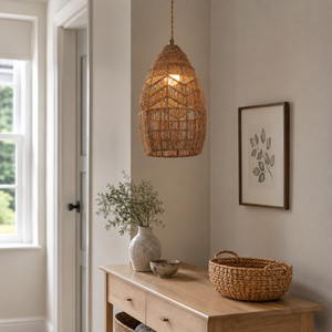 rattan bell pendant light over a warm kitchen counter