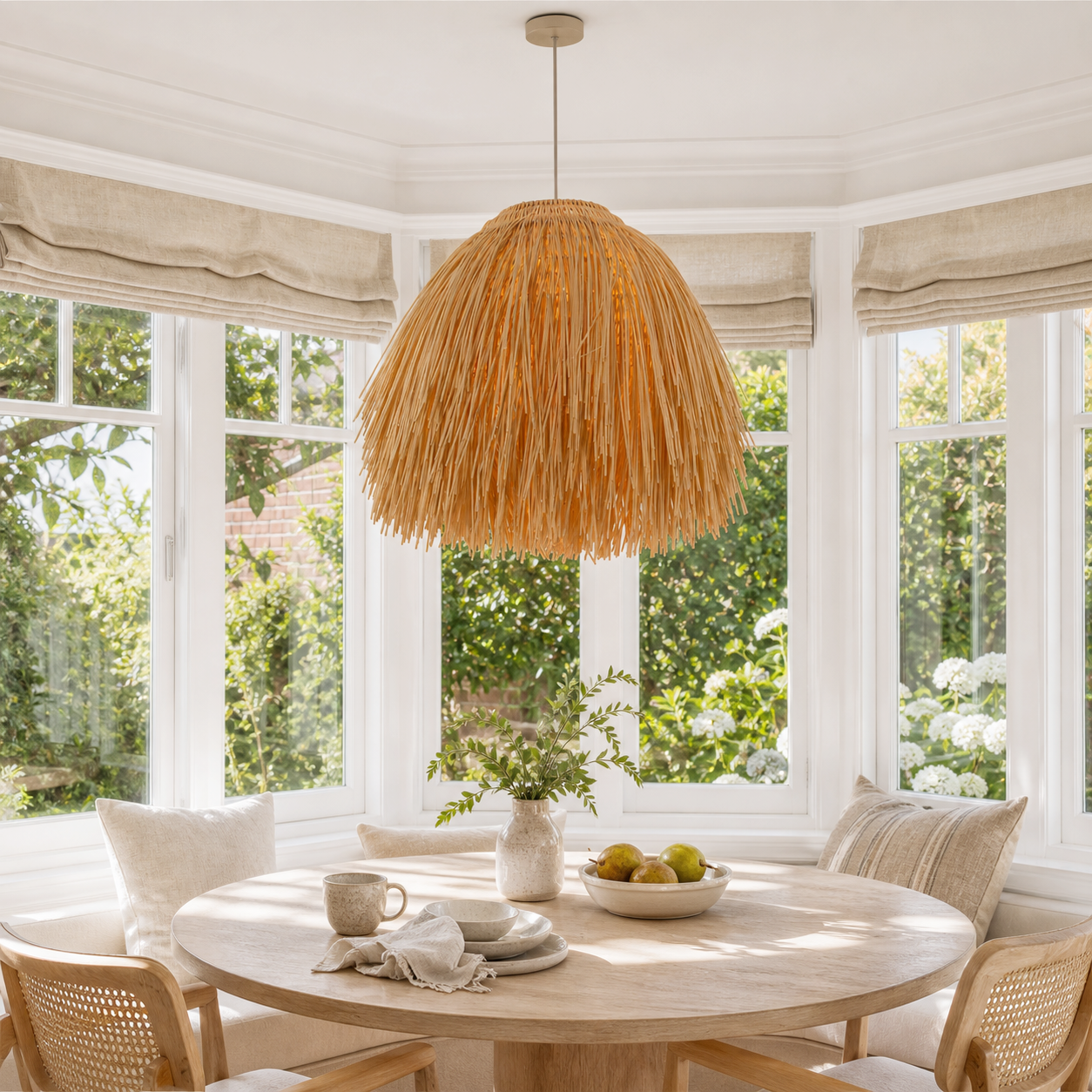 Scarecrow rattan pendant in a sunlit round dining nook