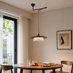 walnut folding acrylic pendant light above a round dining table by a window