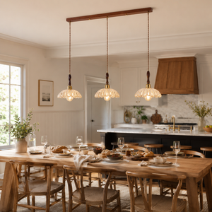 3-light walnut resin mini pendant light above a dining table in an open kitchen