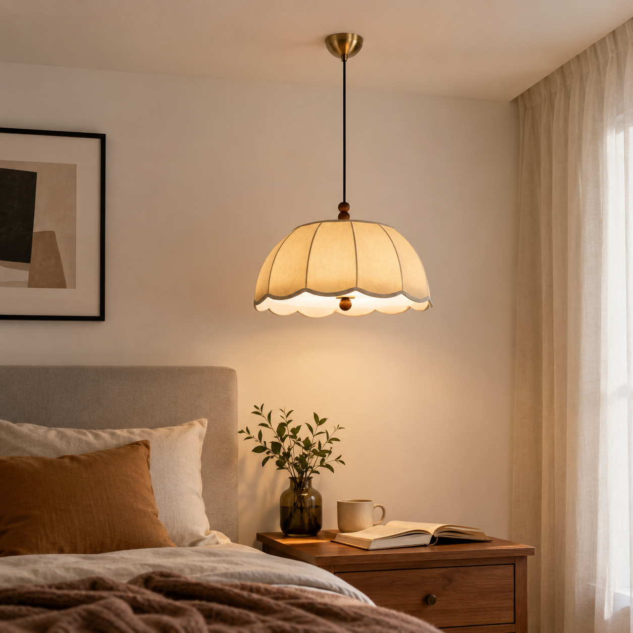 yellow fabric pendant light above a bedside table in a warm bedroom